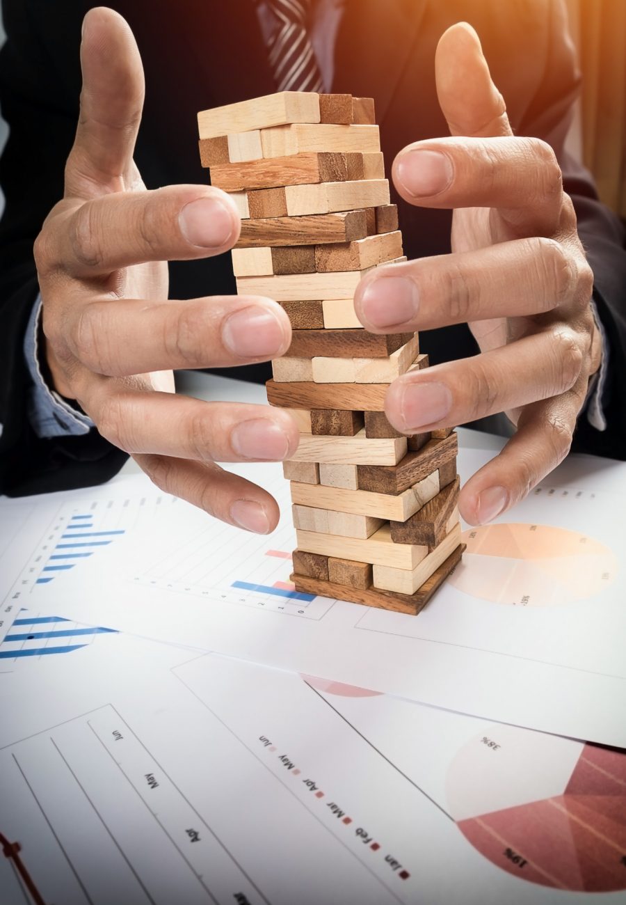 planning-risk-strategy-business-concept-businessman-gambling-placing-wooden-block-tower